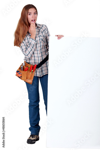Photo: A handywoman amazed by a billboard. A handywoman amazed by a billboard.