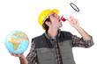 craftsman shouting through a megaphone and holding a globe
