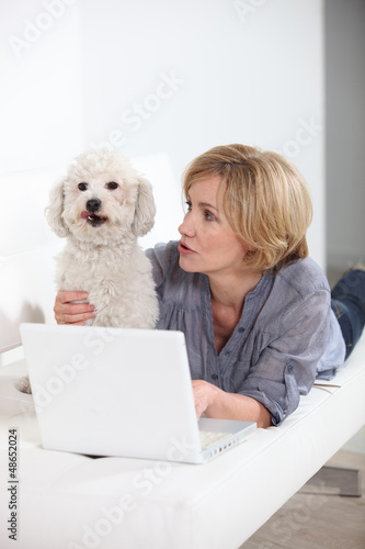 Photo: woman with laptop and dog woman with laptop and dog