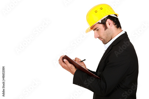 Photo: Surveyor writing on a clipboard Surveyor writing on a clipboard