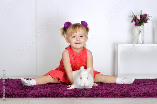Photo: Smiling little girl and white rabbit Smiling little girl and white rabbit