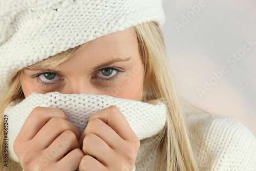 Photo: Woman covering her face with her sweater Woman covering her face with her sweater