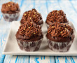 Chocolate cupcakes on a blue table