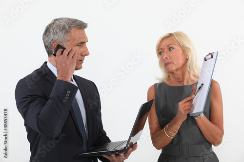 Photo: Senior business couple in the middle of a deal Senior business couple in the middle of a deal