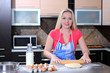 Female cook rolling dough with rolling-pin