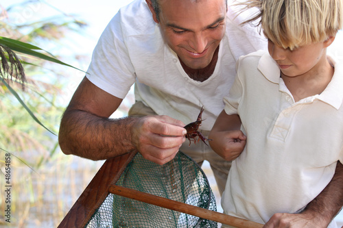 Photo: Father and son with a fishing net Father and son with a fishing net