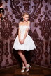 sexy blond bride in white wedding dress in interior