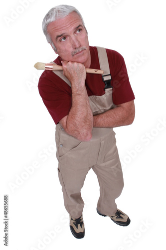 Photo: Grey-haired decorator thinking Grey-haired decorator thinking