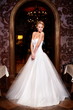 sexy blond bride in white wedding dress in interior