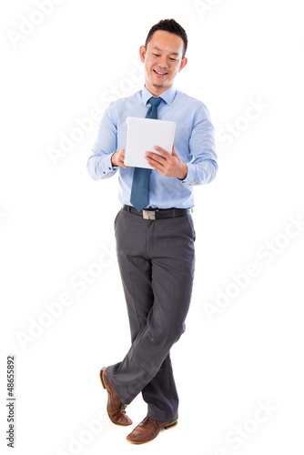 Photo: Asian businessman using tablet-pc Asian businessman using tablet-pc