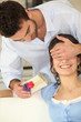 Man giving gift to woman