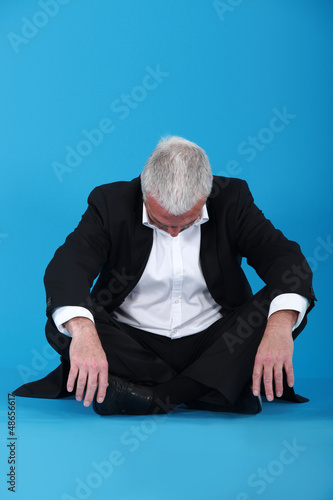 Photo: Grey-haired businessman taking nap Grey-haired businessman taking nap