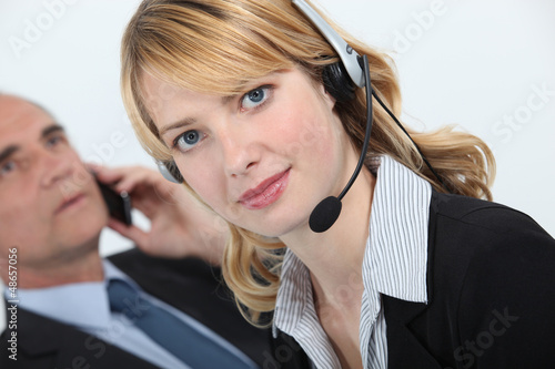 Photo: Secretary wearing a headset Secretary wearing a headset