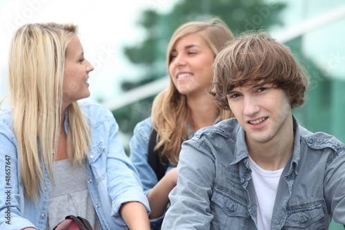 Photo: Three students sitting outside on some steps Three students sitting outside on some steps