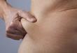 female person checking her belly fat