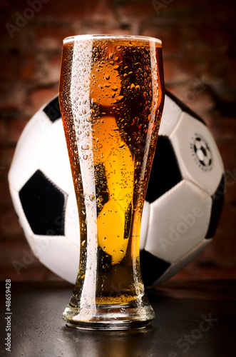 Photo: glass of lager with soccer ball glass of lager with soccer ball