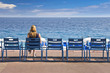 Femme assise sur la Promenade des Anglais - Nice, France