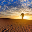 hiker walk by a sandy desert