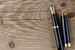 Fountain pen on old wooden background