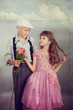 The boy gives a flower to the girl