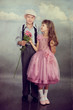 The boy gives a flower to the girl