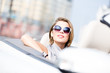 Close up of smiley woman in the cabriolet 