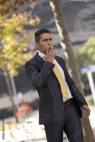 Photo: Businessman smoking a cigar Businessman smoking a cigar