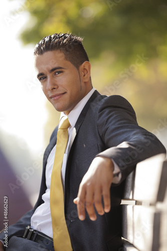 Photo: businessman sited at the bench park businessman sited at the bench park