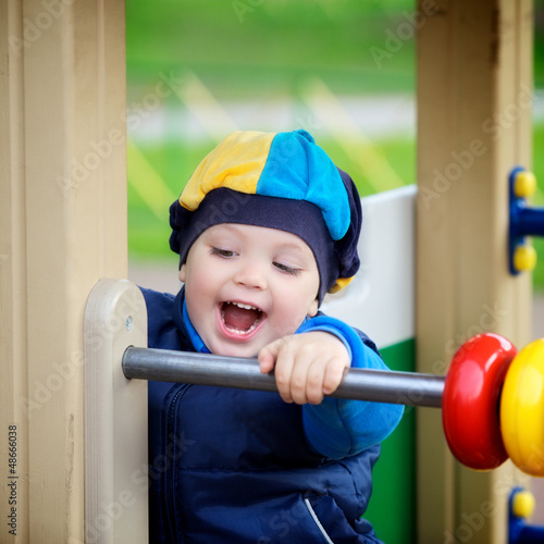 Photo: Boy Playing on Playground Boy Playing on Playground