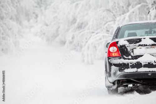 Photo: Black land vehicle standing on winter road on roadside Black land vehicle standing on winter road on roadside