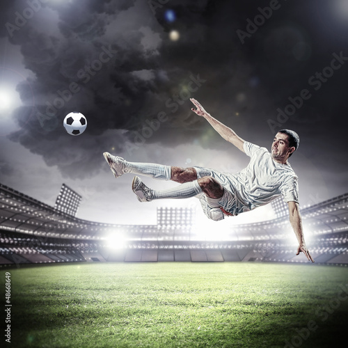 Photo: football player striking the ball football player striking the ball