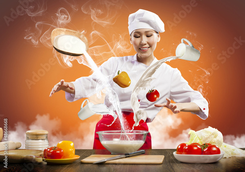 Photo: Asian female cooking with magic Asian female cooking with magic