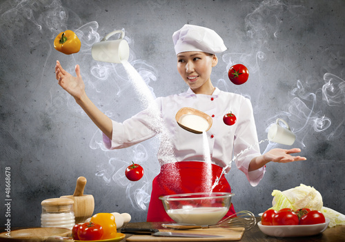 Photo: Asian female cooking with magic Asian female cooking with magic