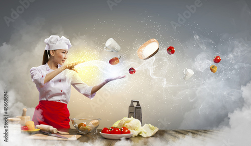 Photo: Asian female cooking with magic Asian female cooking with magic