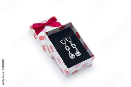 Photo: Silver earrings in a box on white background Silver earrings in a box on white background