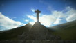Crucifix on the mountain with sunrays