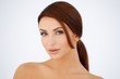 Sensual brown haired woman with bare shoulders
