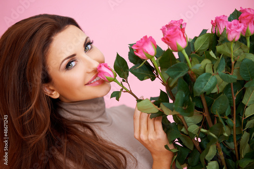 Photo: Beautiful woman smelling a rose Beautiful woman smelling a rose