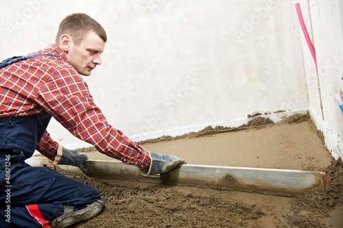 Photo: Plasterer concrete worker at floor work Plasterer concrete worker at floor work