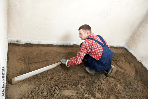 Photo: Plasterer concrete worker at floor work Plasterer concrete worker at floor work