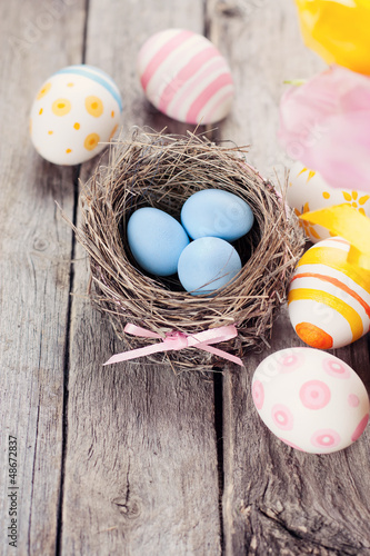 Photo: Easter eggs on a wooden background Easter eggs on a wooden background