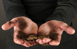 homeless man holding a coins, close-up