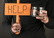 homeless man asks for help, on black background close-up