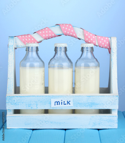 Photo: Milk in bottles in wooden box Milk in bottles in wooden box