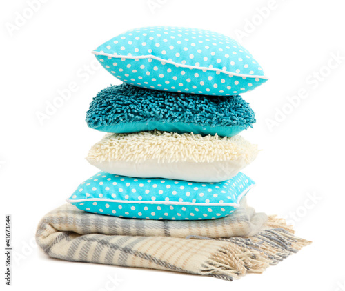 Photo: Hill colorful pillows and plaid on green background Hill colorful pillows and plaid on green background