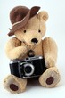 Schmuseteddy mit Kamera weißer Hintergrund