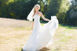 Portrait of beautiful blond bride in action. Wedding dress.