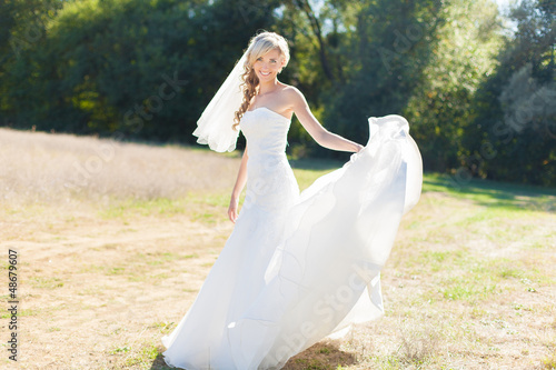 Photo: Portrait of beautiful blond bride in action. Wedding dress. Portrait of beautiful blond bride in action. Wedding dress.