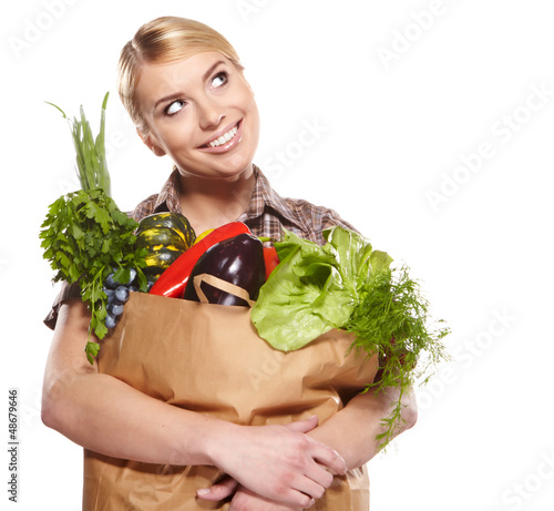 Photo: Woman with a shopping bag filled with nutritious fruit and veget Woman with a shopping bag filled with nutritious fruit and veget