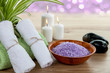 SPA with aromatic burning candles, towel and lavender bath salt